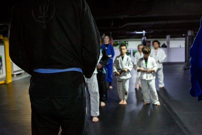 Children with the coach on kids mma training