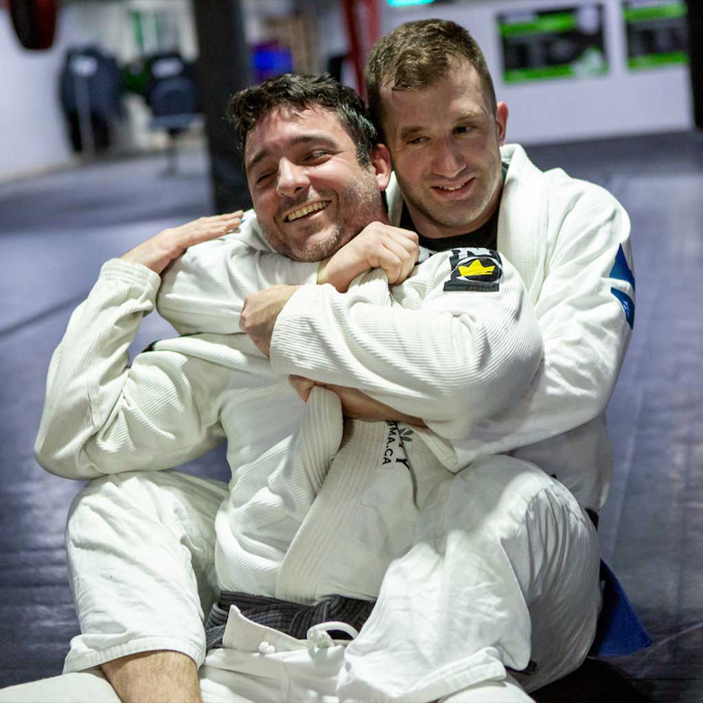 Men smiling on brazilian jiu-jitsu training